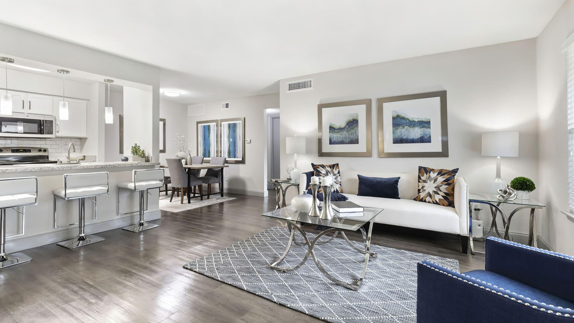 a clean and modern living room with hardwood floors at The  Adelene