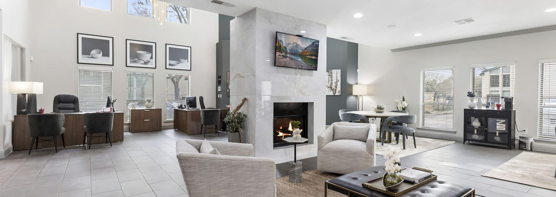 the living room has a fireplace and a large television at The  Adelene