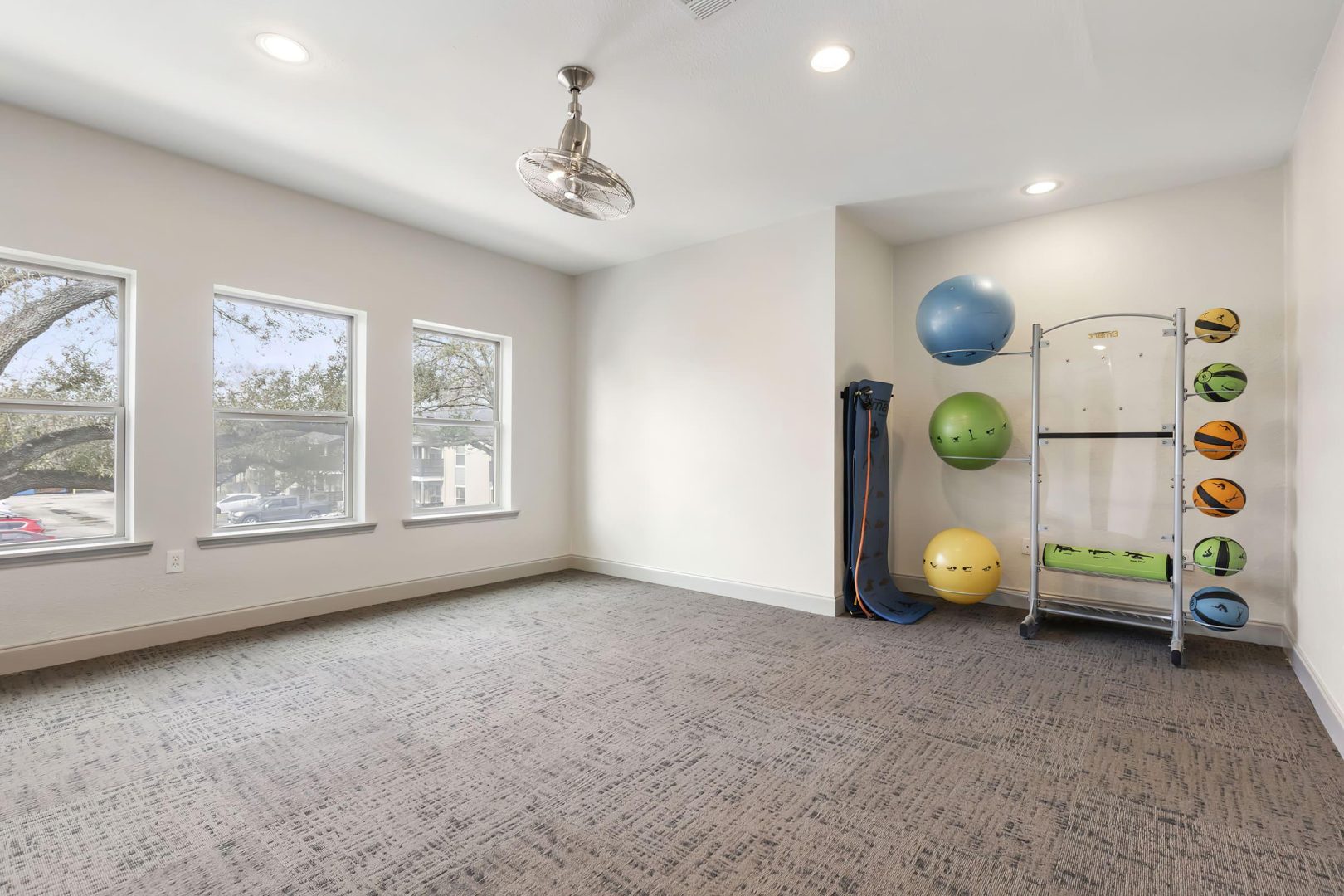 a gym room with a large exercise ball and weights at The  Adelene