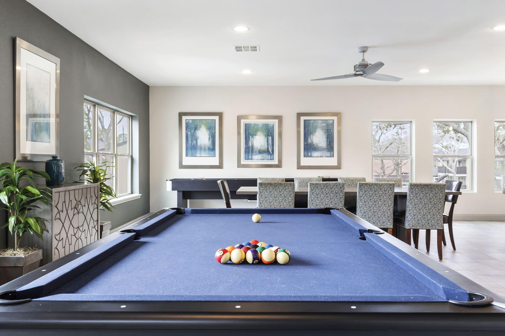 a pool table in a living room with a dining table at The  Adelene